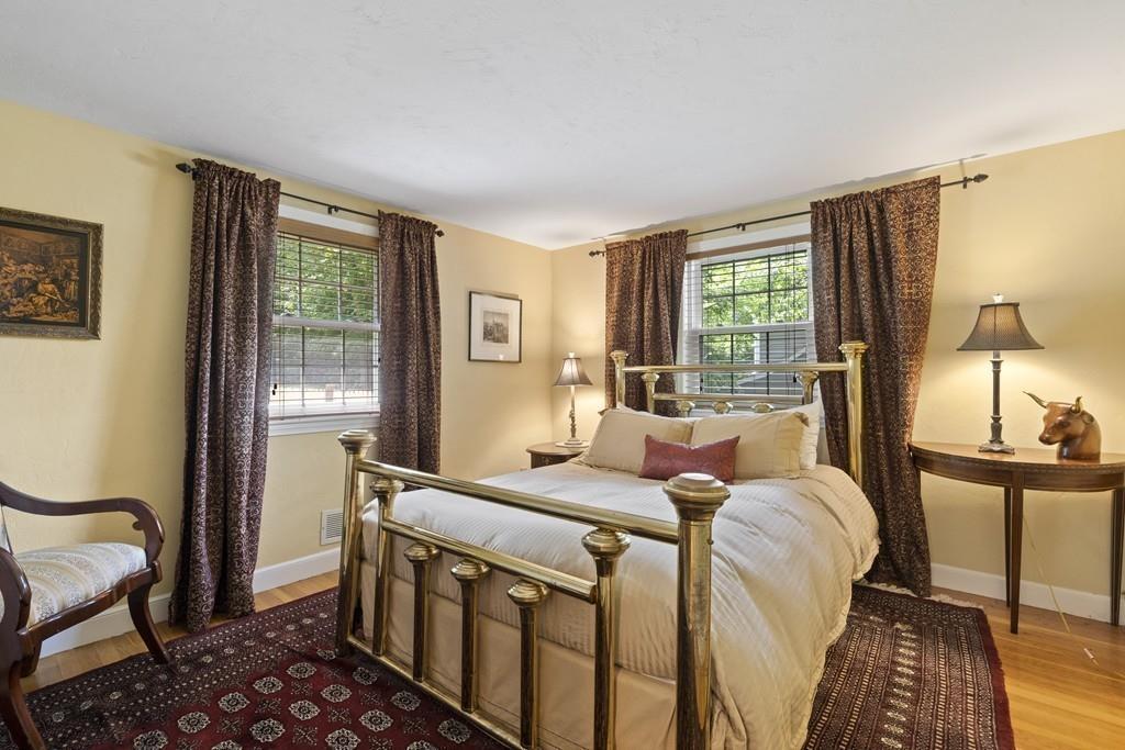 56 Ledgewood Road Dedham, MA 02026 - Photo 20 of 36 a bedroom with a bed and wooden floor