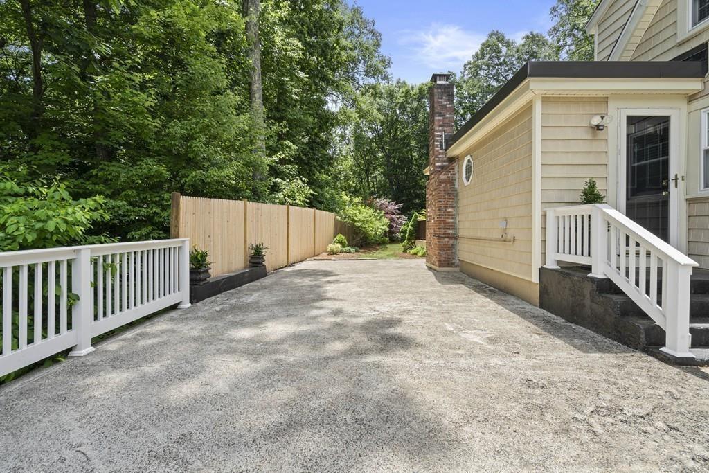 56 Ledgewood Road Dedham, MA 02026 - Photo 35 of 36 a view of a house with a small yard and wooden fence