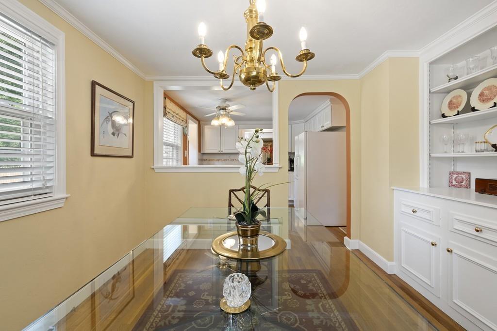 56 Ledgewood Road Dedham, MA 02026 - Photo 9 of 36 a dining room with wooden floor a chandelier a wooden table and chairs
