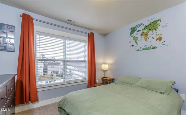 a bedroom with a bed and a painting on the wall