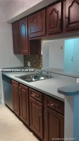 a kitchen with a refrigerator and a stove