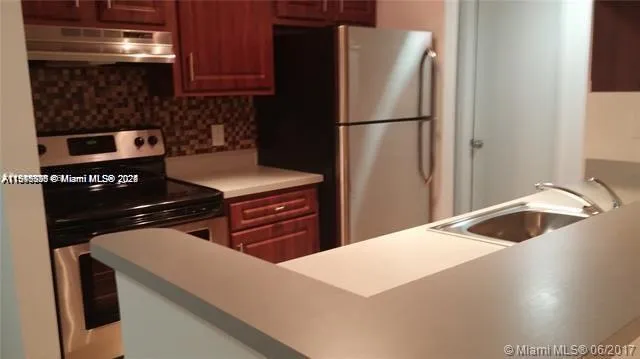 a kitchen with a sink and refrigerator