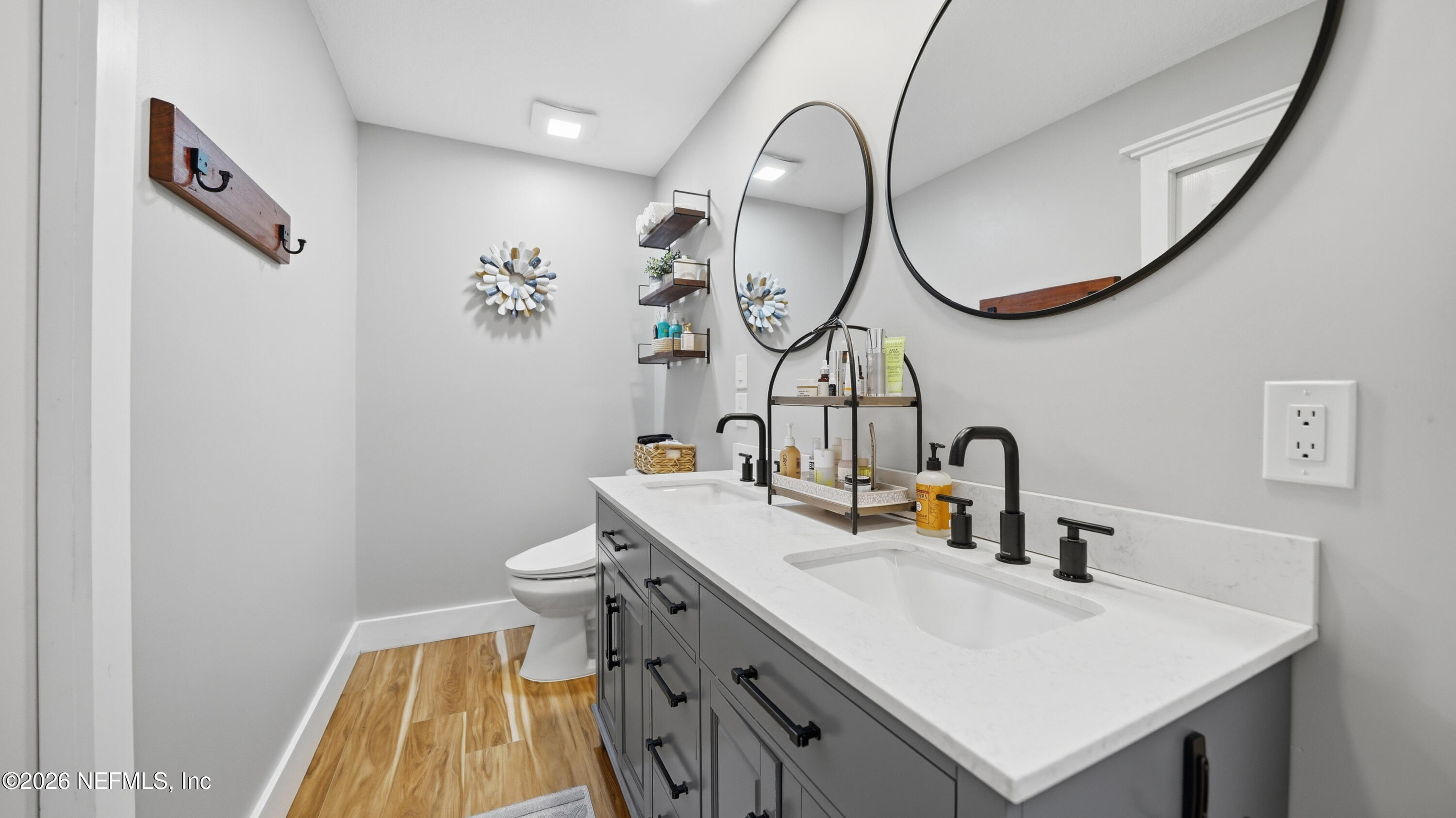 1703 Pelican Place Middleburg, FL 32068 - Photo 51 of 99 a bathroom with a sink a toilet and a mirror