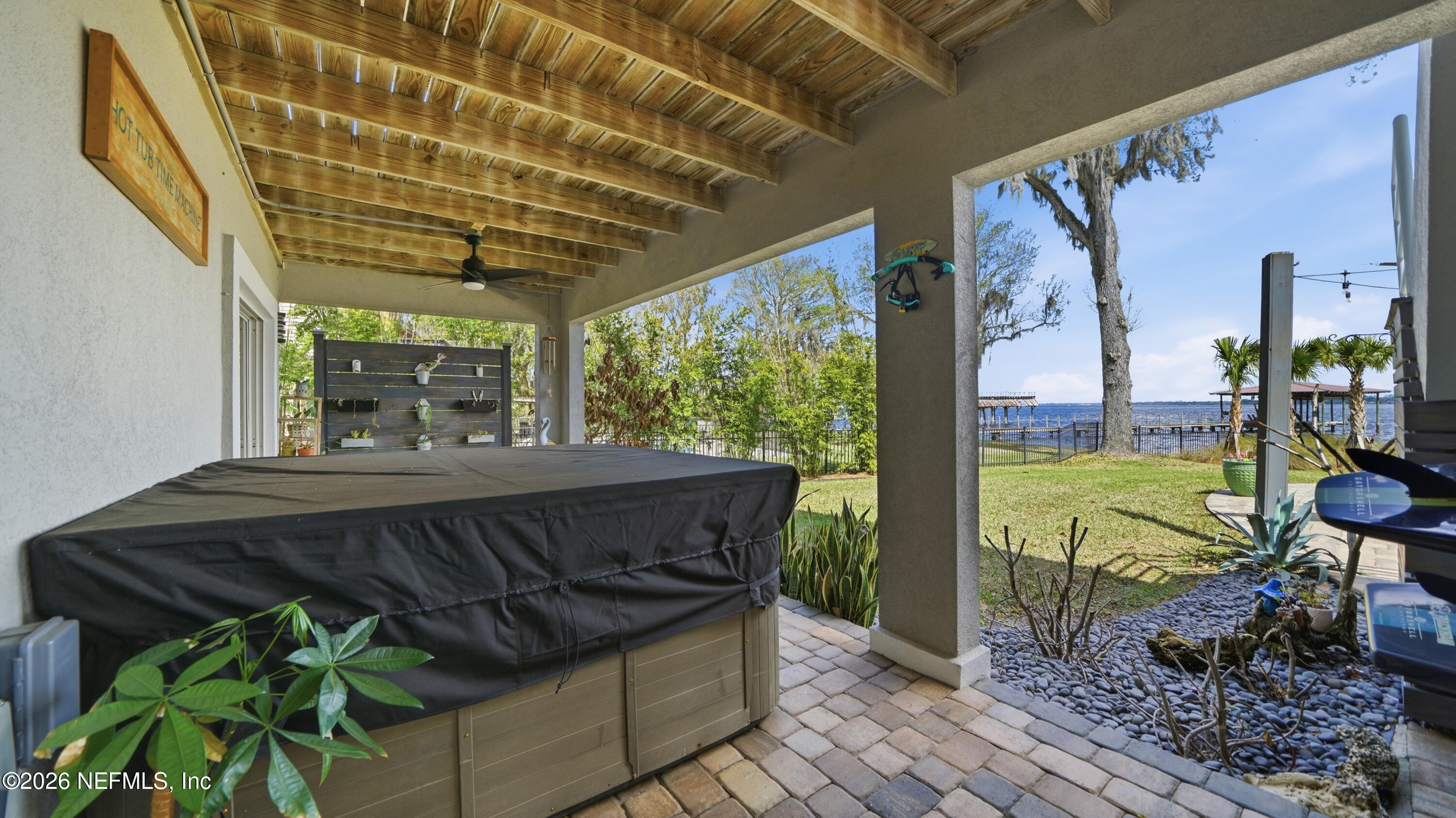 1703 Pelican Place Middleburg, FL 32068 - Photo 77 of 99 a view of a patio with table and chairs potted plants with floor to ceiling window