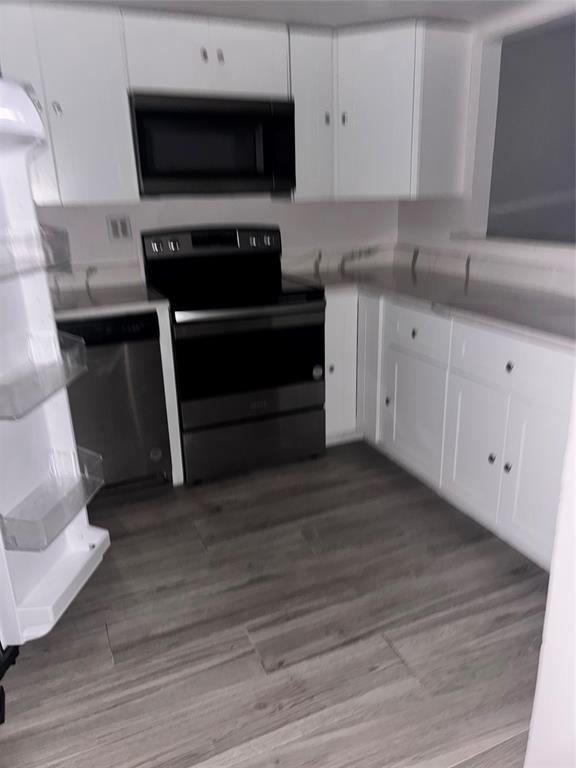 4761 Northwest 2nd Avenue, Unit 307 Boca Raton, FL 33431 - Photo 12 of 15 a kitchen with stainless steel appliances a stove a microwave and a sink