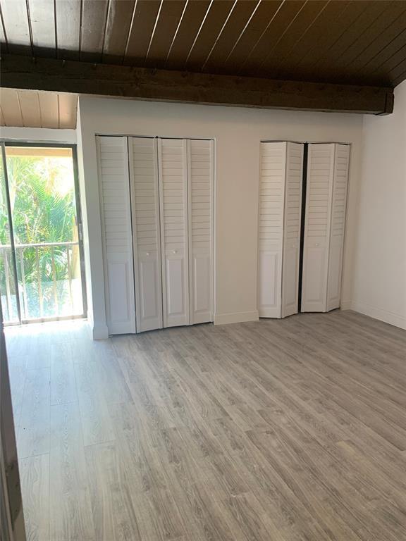 4761 Northwest 2nd Avenue, Unit 307 Boca Raton, FL 33431 - Photo 3 of 15 a view of an empty room with wooden floor and a window