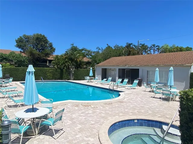 a view of a house with swimming pool and sitting area