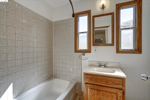 a bedroom with a large bed and a potted plant