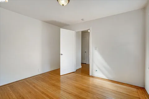 a room with a table chairs and a window