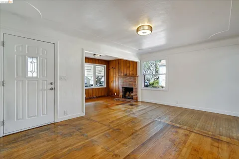a living room with a fireplace and windows