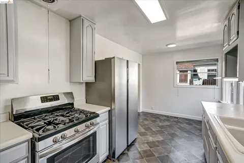 a kitchen with a sink cabinets and window