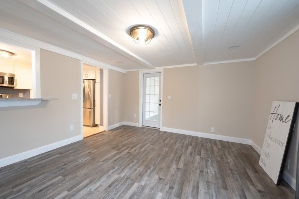 7 Weyham Road Weymouth, MA 02191 - Photo 15 of 38 a view of an empty room with wooden floor and a window