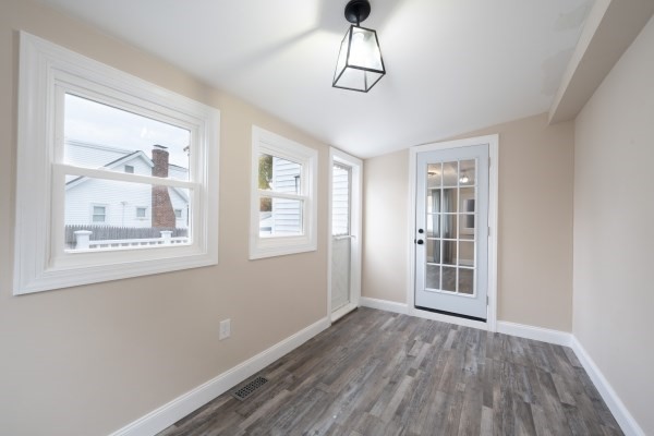 7 Weyham Road Weymouth, MA 02191 - Photo 16 of 38 a view of empty room with wooden floor and fan