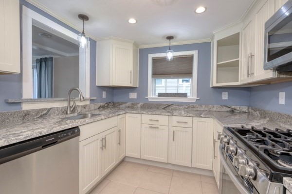 7 Weyham Road Weymouth, MA 02191 - Photo 5 of 38 a kitchen with granite countertop white cabinets and a stove