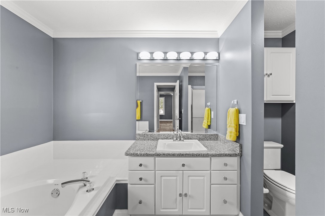 4500 Brooks Road Cleveland, OH 44105 - Photo 25 of 50 Primary bathroom featuring vanity, ornamental molding, and a bath