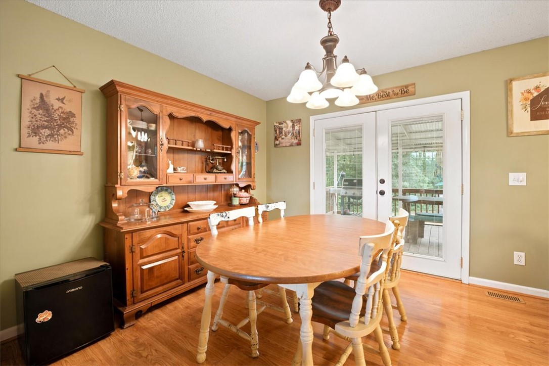 520 Sharon Lane Seneca, SC 29678 - Photo 17 of 48 A well-lit dining area featuring rich hardwood flooring and convenient access to the outdoors.