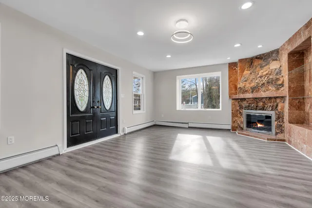 a view of a small space with wooden floor and a window