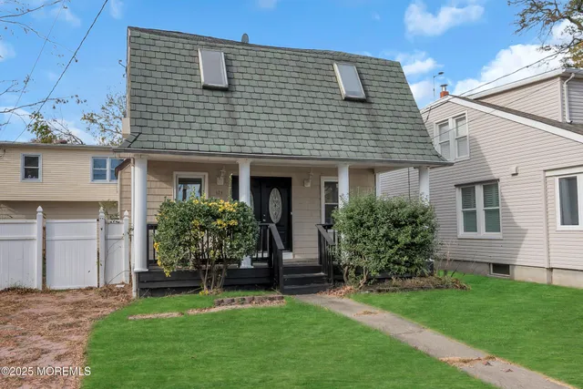 a front view of a house with a garden and plants