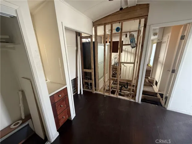 a view of a hallway with wooden floor and stairs