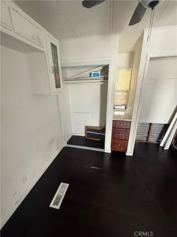a view of a hallway with wooden floor and stairs