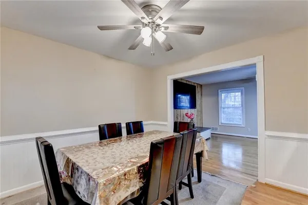 a view of a dining room with furniture and wooden floor