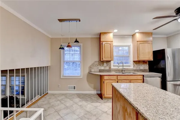 a kitchen with stainless steel appliances granite countertop a sink stove and refrigerator