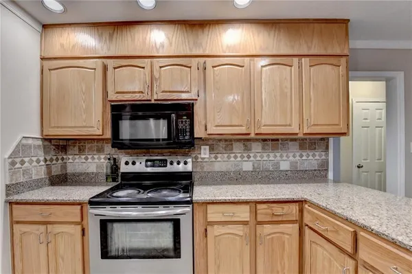 a kitchen with a stove and a microwave