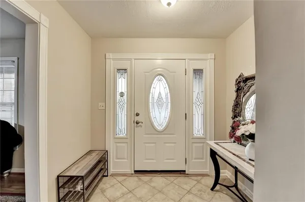 a living room with furniture and a mirror