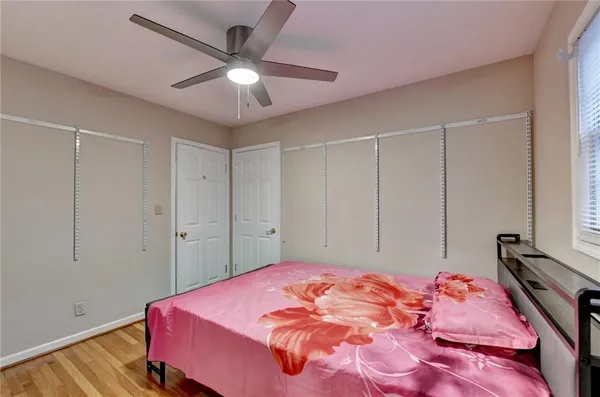 a view of empty room with wooden floor
