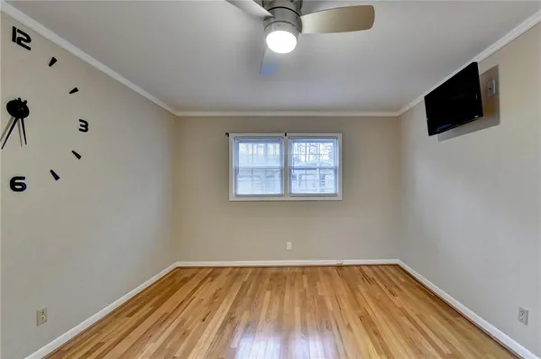a view of an empty room with wooden floor
