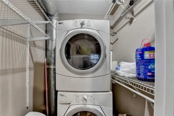 a bedroom with a bed and dresser with mirror