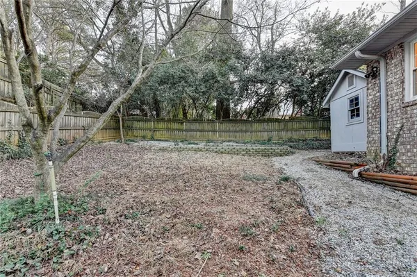 a kitchen with stainless steel appliances granite countertop a refrigerator a stove a sink and a microwave