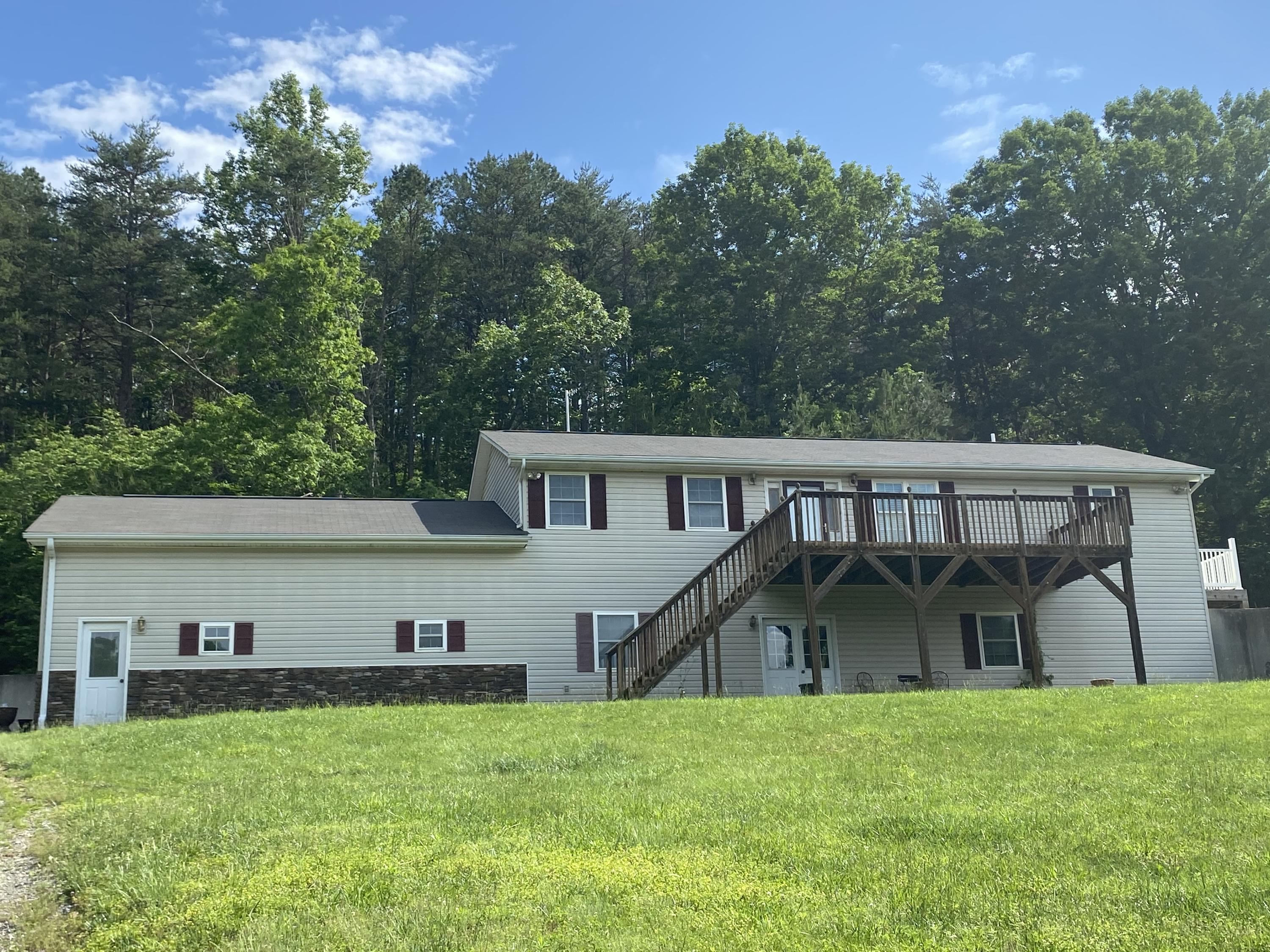 1469 Crouch Road Montvale, VA 24122 - Photo 1 of 23 a front view of a house with a yard table and chairs