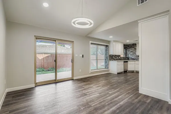 a view of kitchen with wooden floor and window