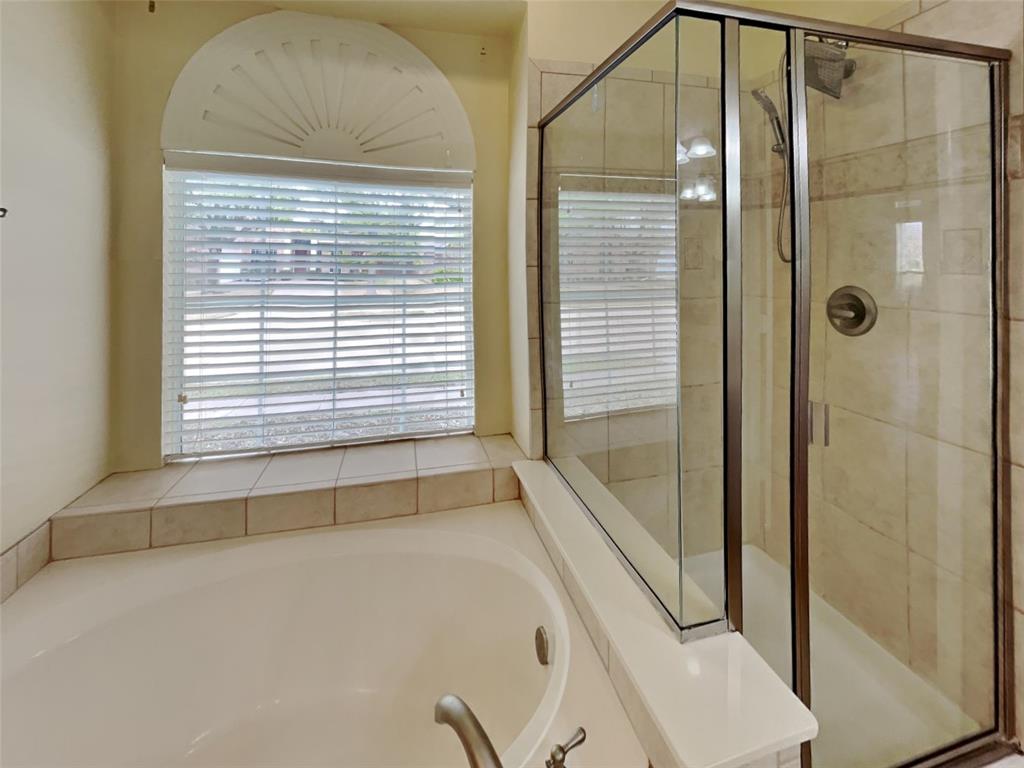 10805 Winged Foot Drive Rowlett, TX 75089 - Photo 13 of 26 a bathroom with a bathtub and a shower