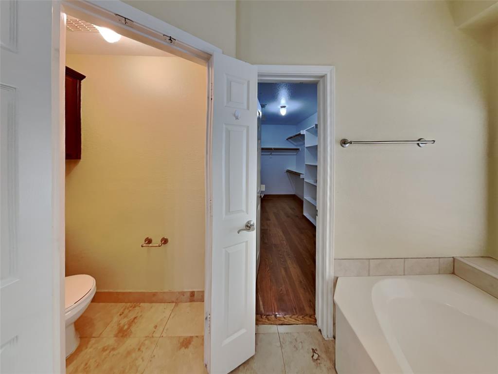 10805 Winged Foot Drive Rowlett, TX 75089 - Photo 14 of 26 a bathroom with a bathtub and a shower