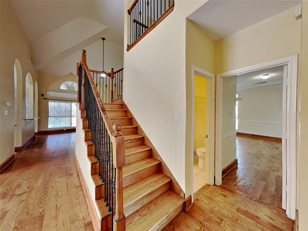 10805 Winged Foot Drive Rowlett, TX 75089 - Photo 18 of 26 a view of a hallway with wooden floor and staircase