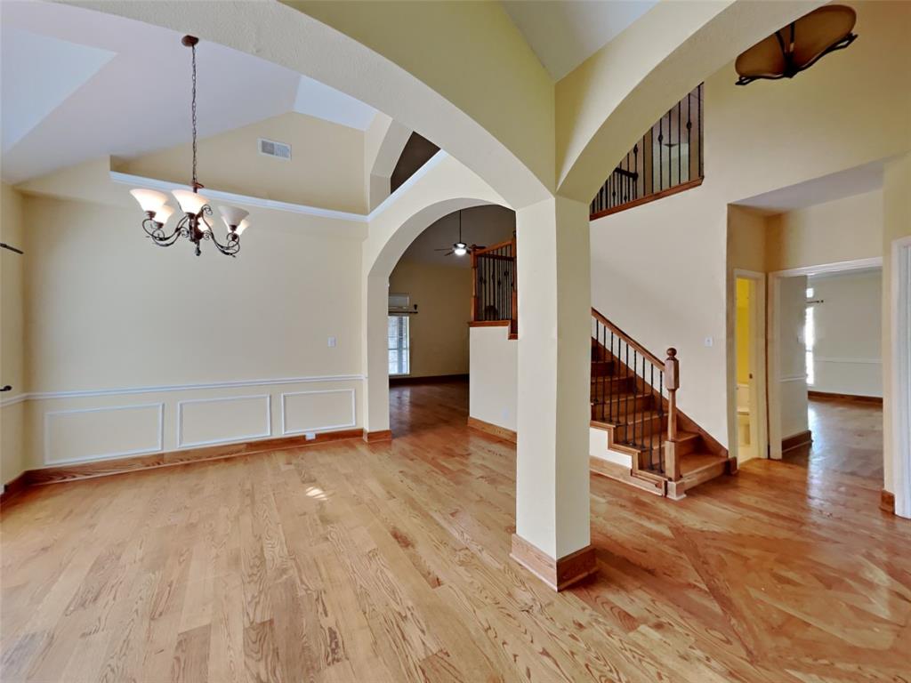10805 Winged Foot Drive Rowlett, TX 75089 - Photo 3 of 26 a view of a hallway with wooden floor and staircase