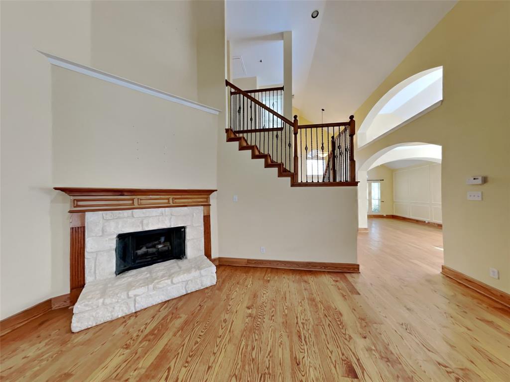 10805 Winged Foot Drive Rowlett, TX 75089 - Photo 4 of 26 a living room with wooden floor and a fireplace
