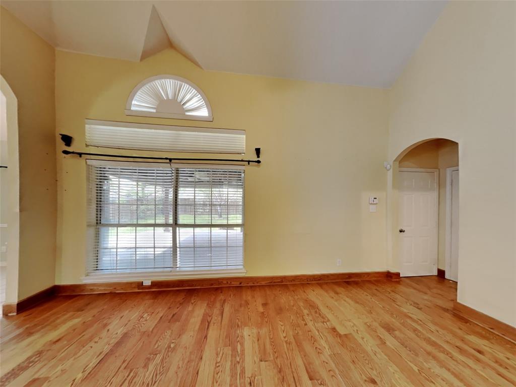 10805 Winged Foot Drive Rowlett, TX 75089 - Photo 5 of 26 a view of an empty room with wooden floor and a window