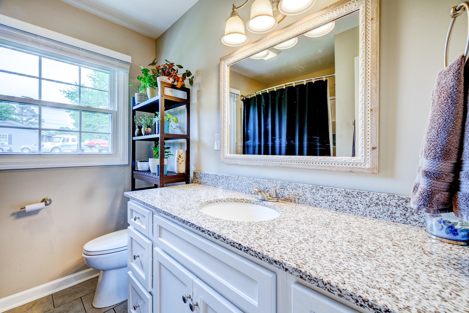 1721 Midland Road Shelbyville, TN 37160 - Photo 19 of 29 a bathroom with a granite countertop sink a large mirror and a toilet