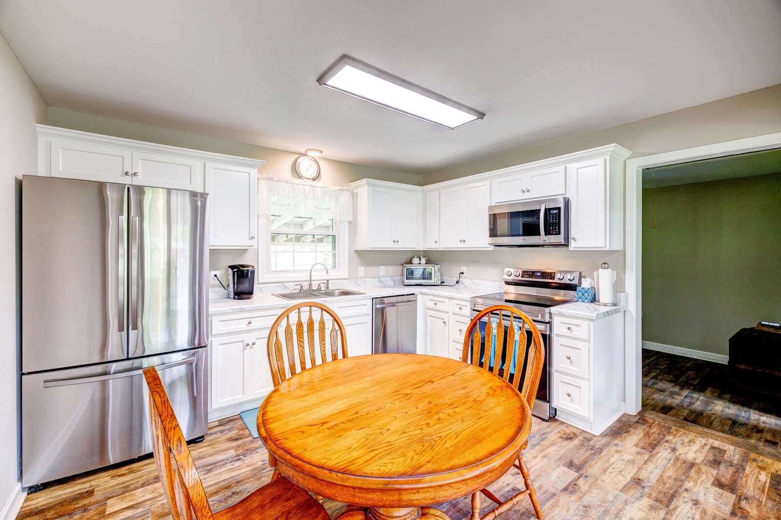 1721 Midland Road Shelbyville, TN 37160 - Photo 8 of 29 a kitchen with stainless steel appliances a refrigerator a sink a stove a dining table and chairs