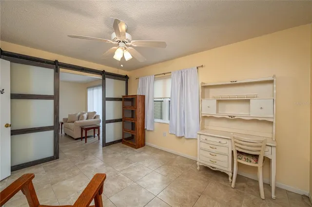 a room with furniture and a ceiling fan
