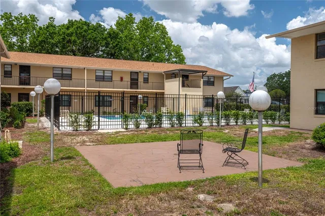 a front view of a house with a yard table and chairs