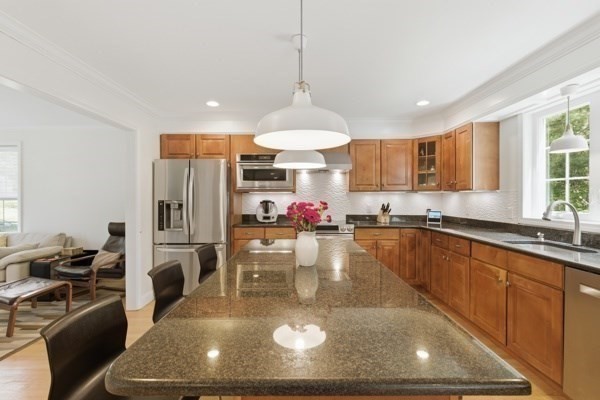 3 Wing Road Wilmington, MA 01887 - Photo 6 of 36 a large kitchen with stainless steel appliances granite countertop a sink refrigerator and cabinets