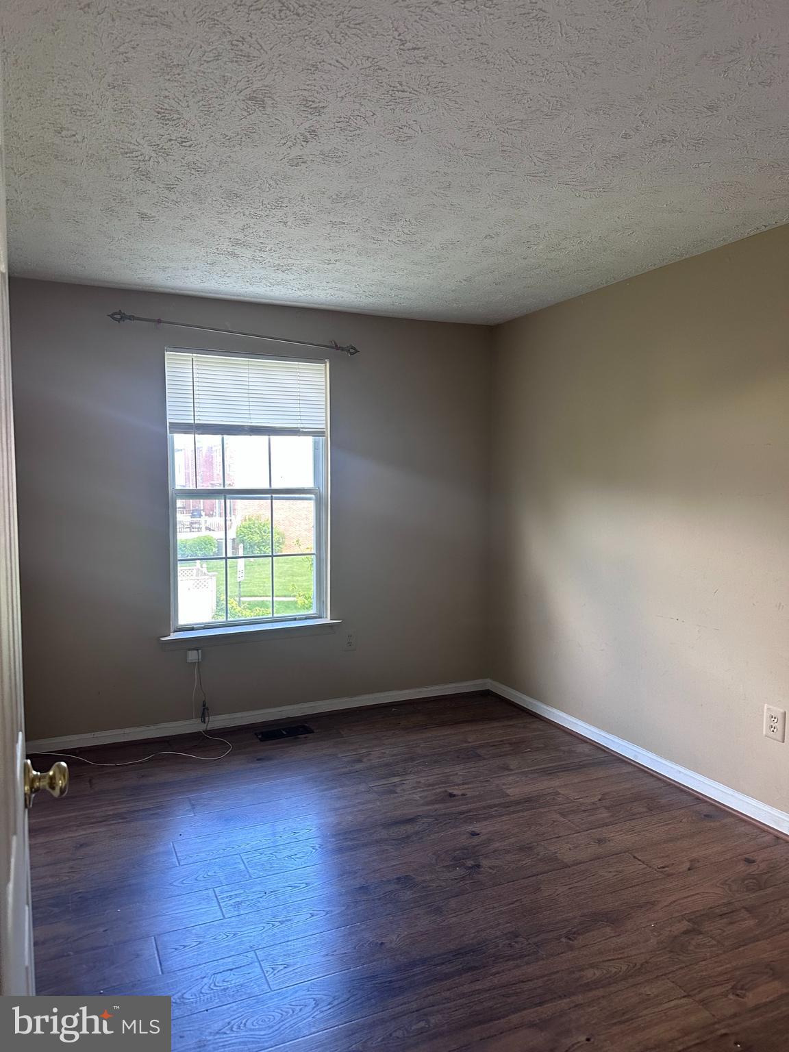 1488 Dockside Court Frederick, MD 21701 - Photo 12 of 16 an empty room with wooden floor and windows
