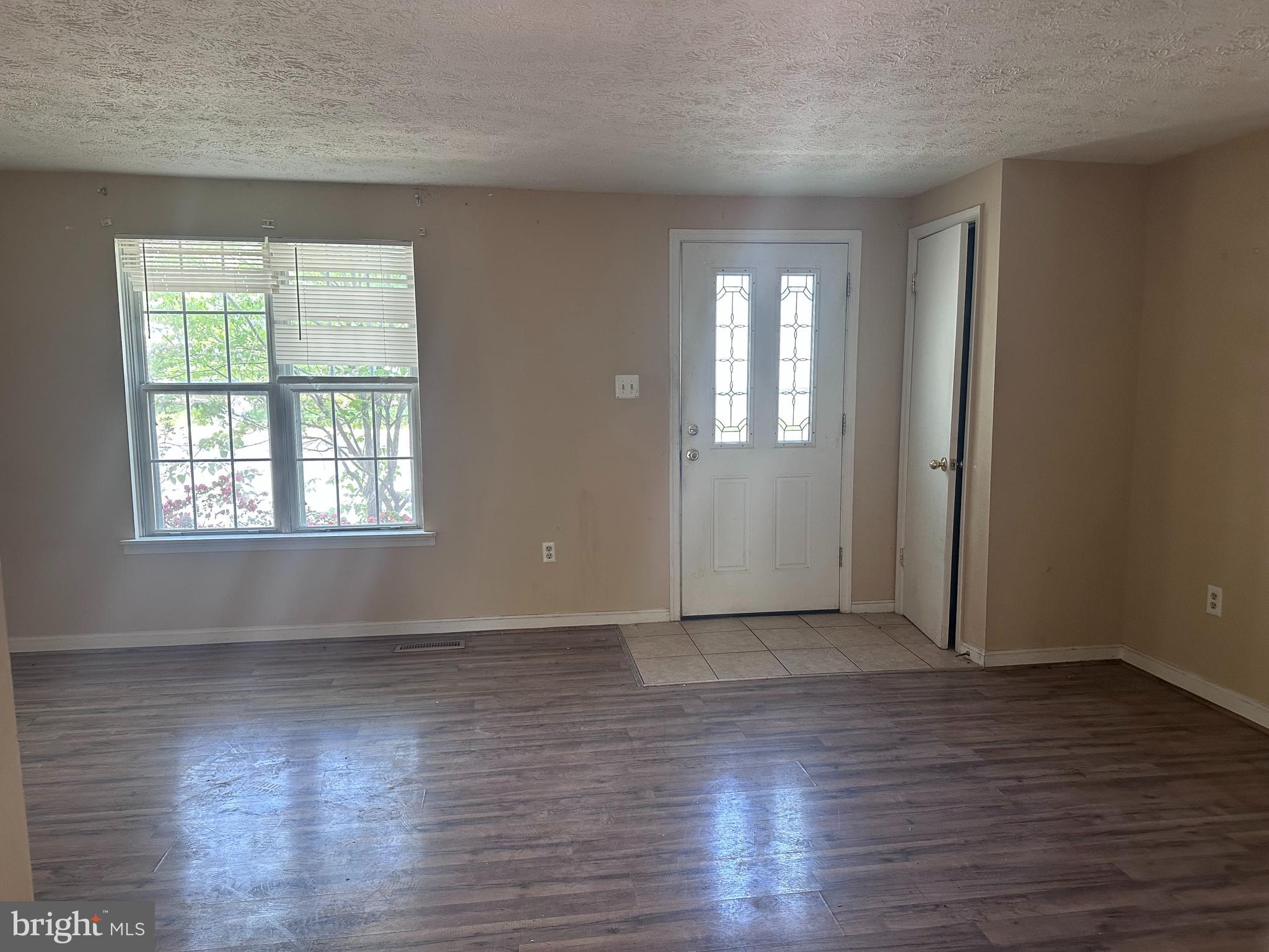 1488 Dockside Court Frederick, MD 21701 - Photo 4 of 16 an empty room with wooden floor and windows