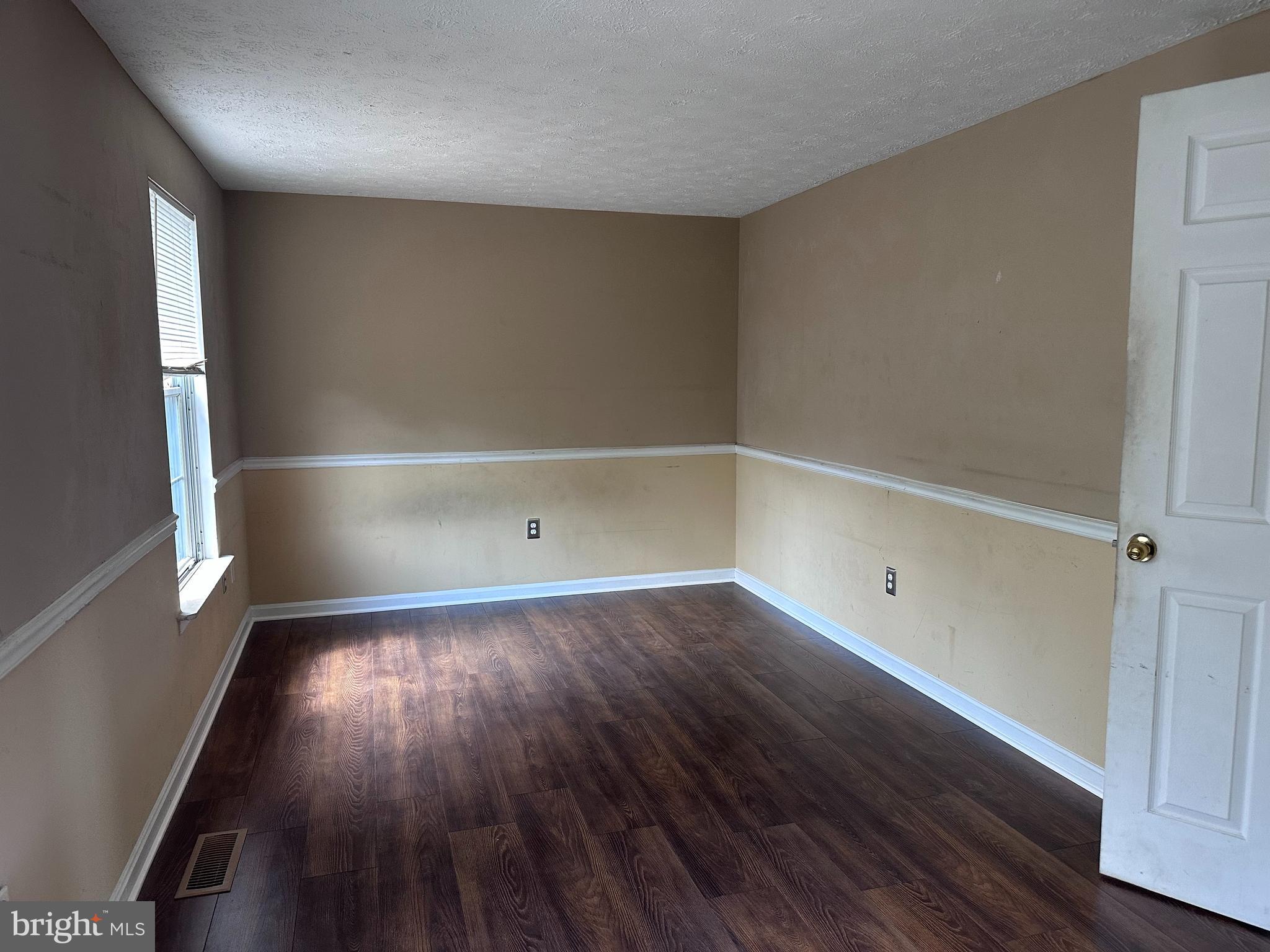 1488 Dockside Court Frederick, MD 21701 - Photo 8 of 16 an empty room with wooden floor and windows