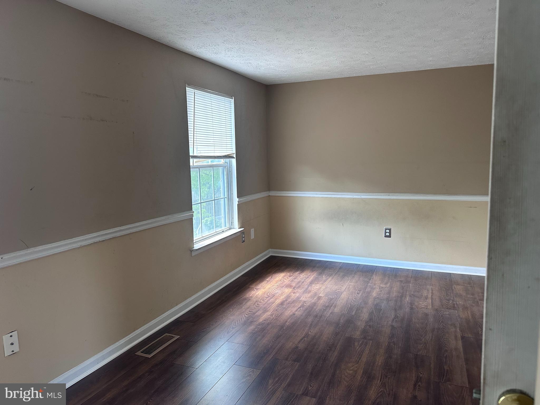 1488 Dockside Court Frederick, MD 21701 - Photo 9 of 16 an empty room with wooden floor and windows