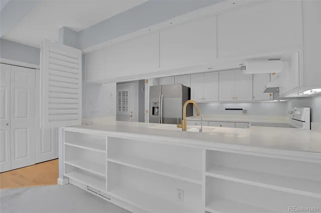 a kitchen with cabinets appliances and a window